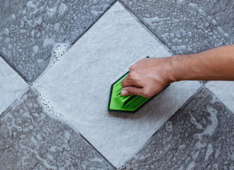 640-cleaning-the-tiled-floor-with-a-plastic-floor-scrubber (1)