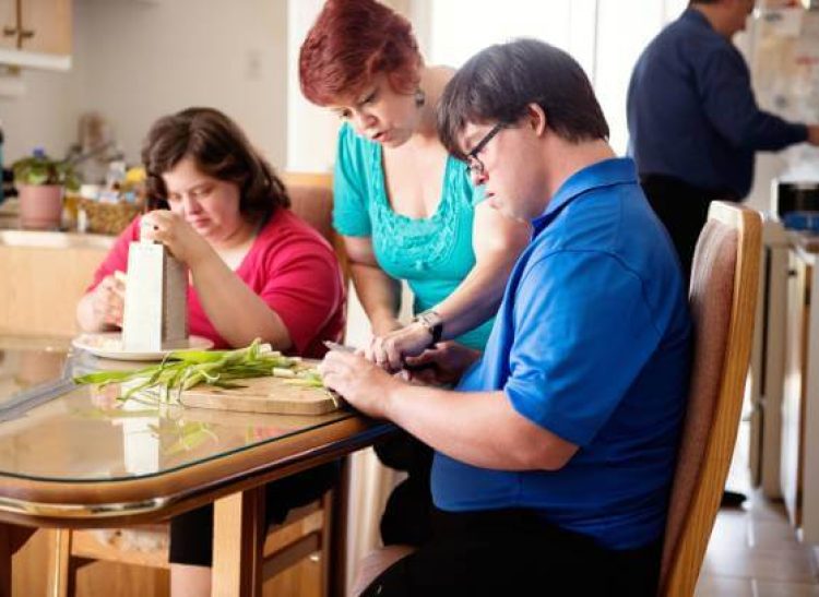 Support worker assisting individuals with disabilities in preparing food and performing daily personal activities in Dubbo